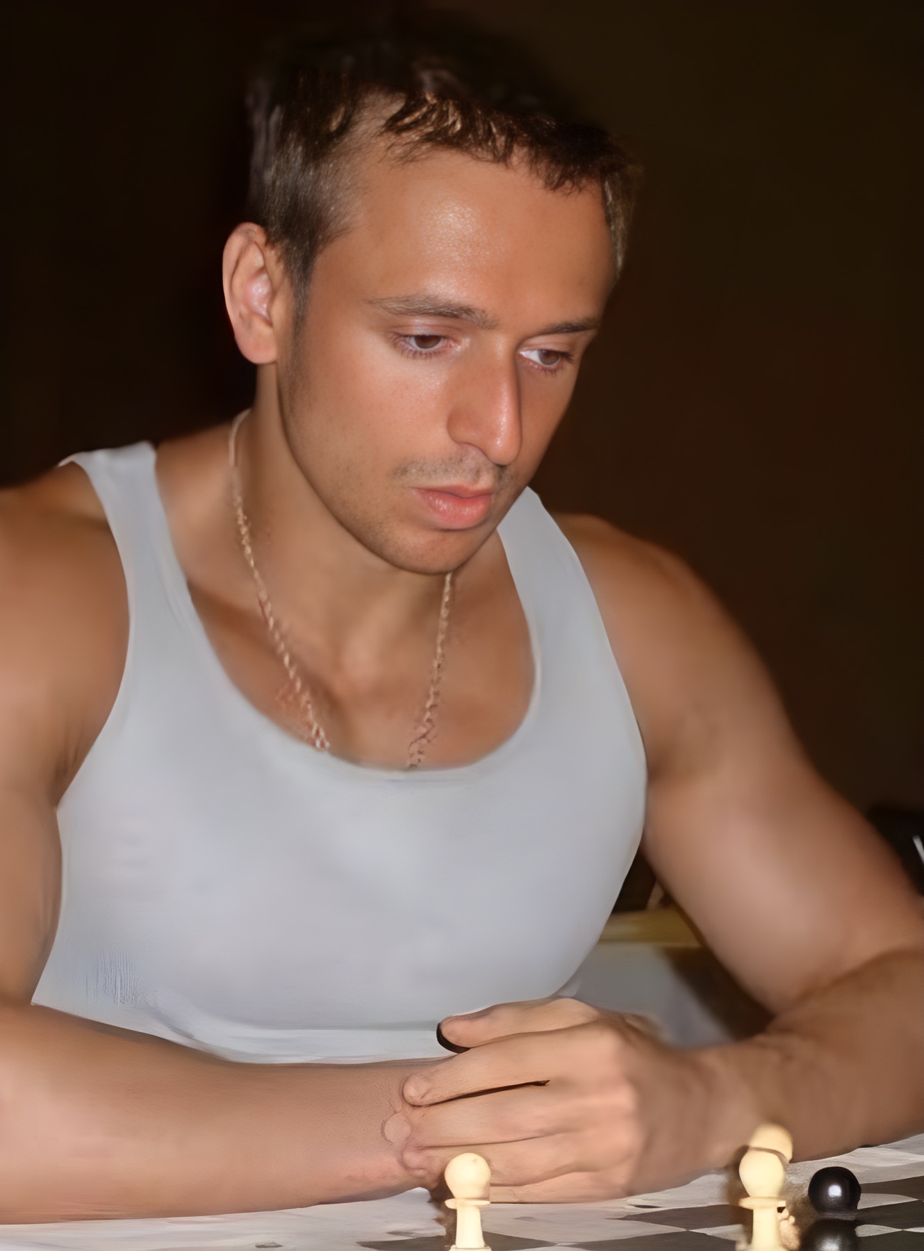 Young Boris Kreiman studying a position with intense focus